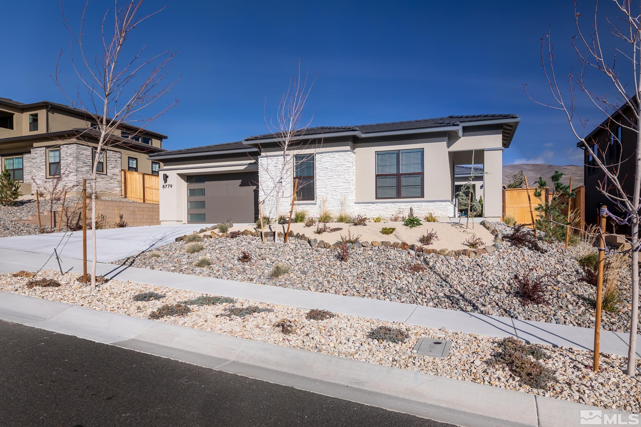 8779 Larkhaven Trail Reno, NV 89523 - Photo 2 of 32 a view of a house with snow on the side of the road