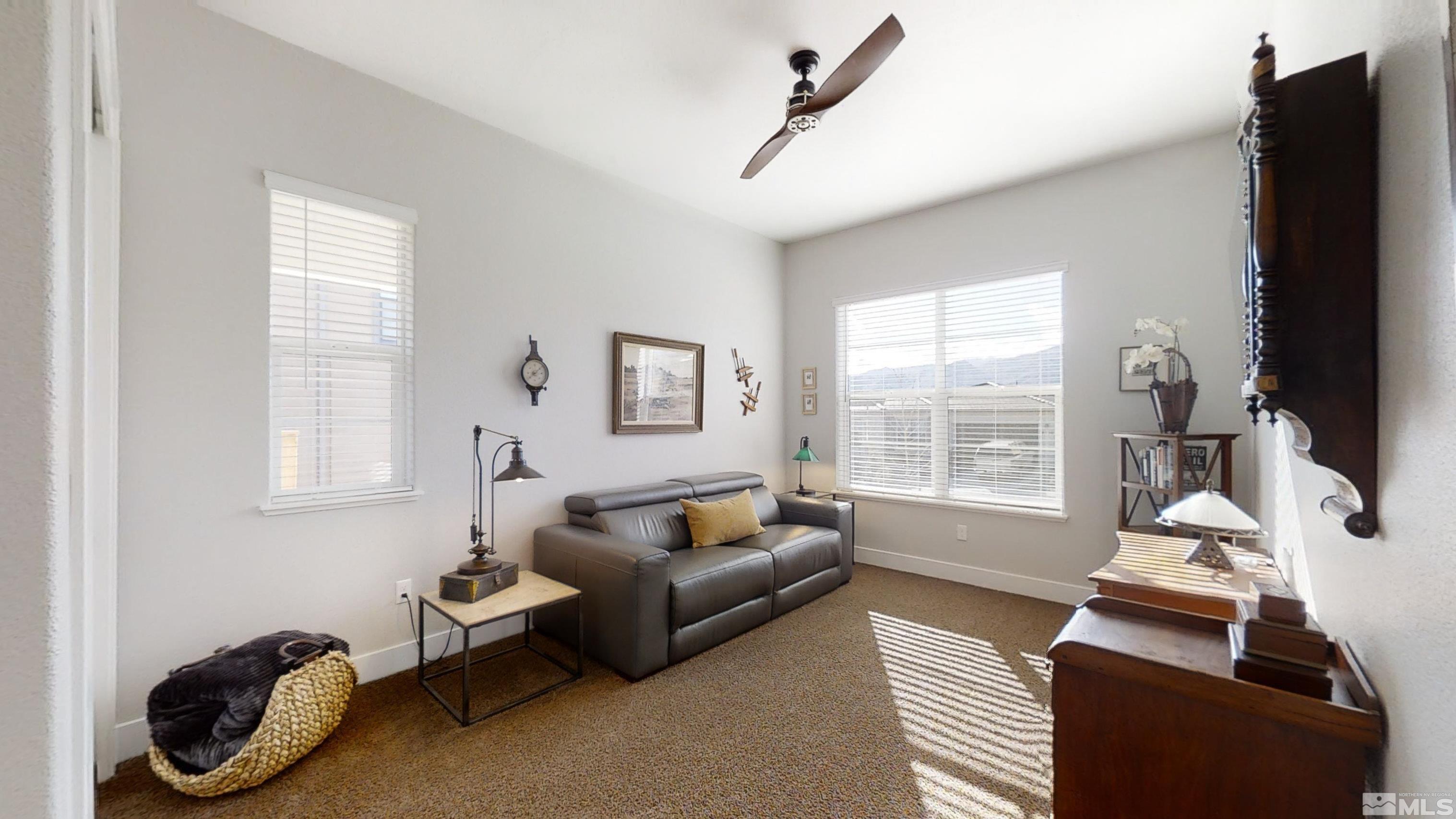 8779 Larkhaven Trail Reno, NV 89523 - Photo 25 of 32 a living room with furniture and a flat screen tv