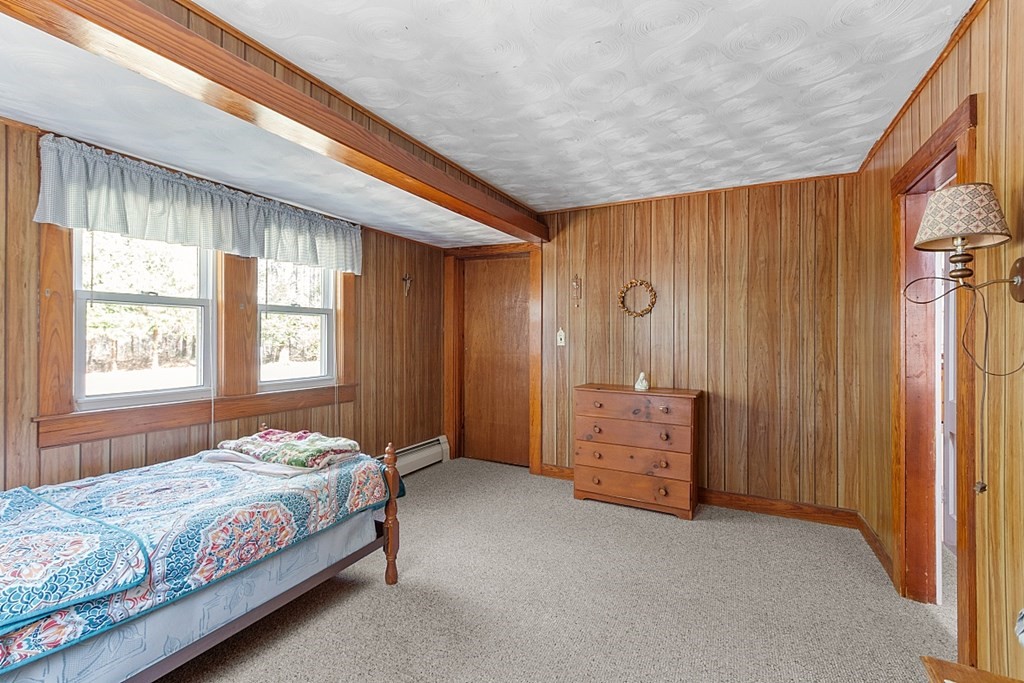 10 R Eagleville Road Orange, MA 01364 - Photo 18 of 29 a bedroom with a bed and a chandelier