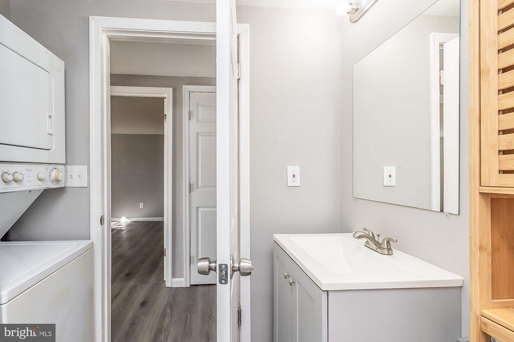 4006 Pinewood Avenue, Unit 1 Baltimore, MD 21206 - Photo 12 of 25 a bathroom with a sink a toilet and a mirror