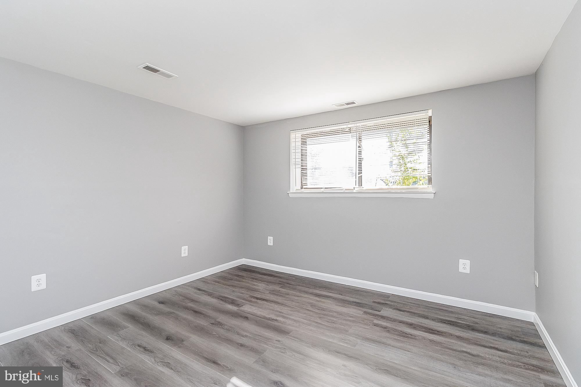4006 Pinewood Avenue, Unit 1 Baltimore, MD 21206 - Photo 14 of 25 wooden floor in an empty room with a window