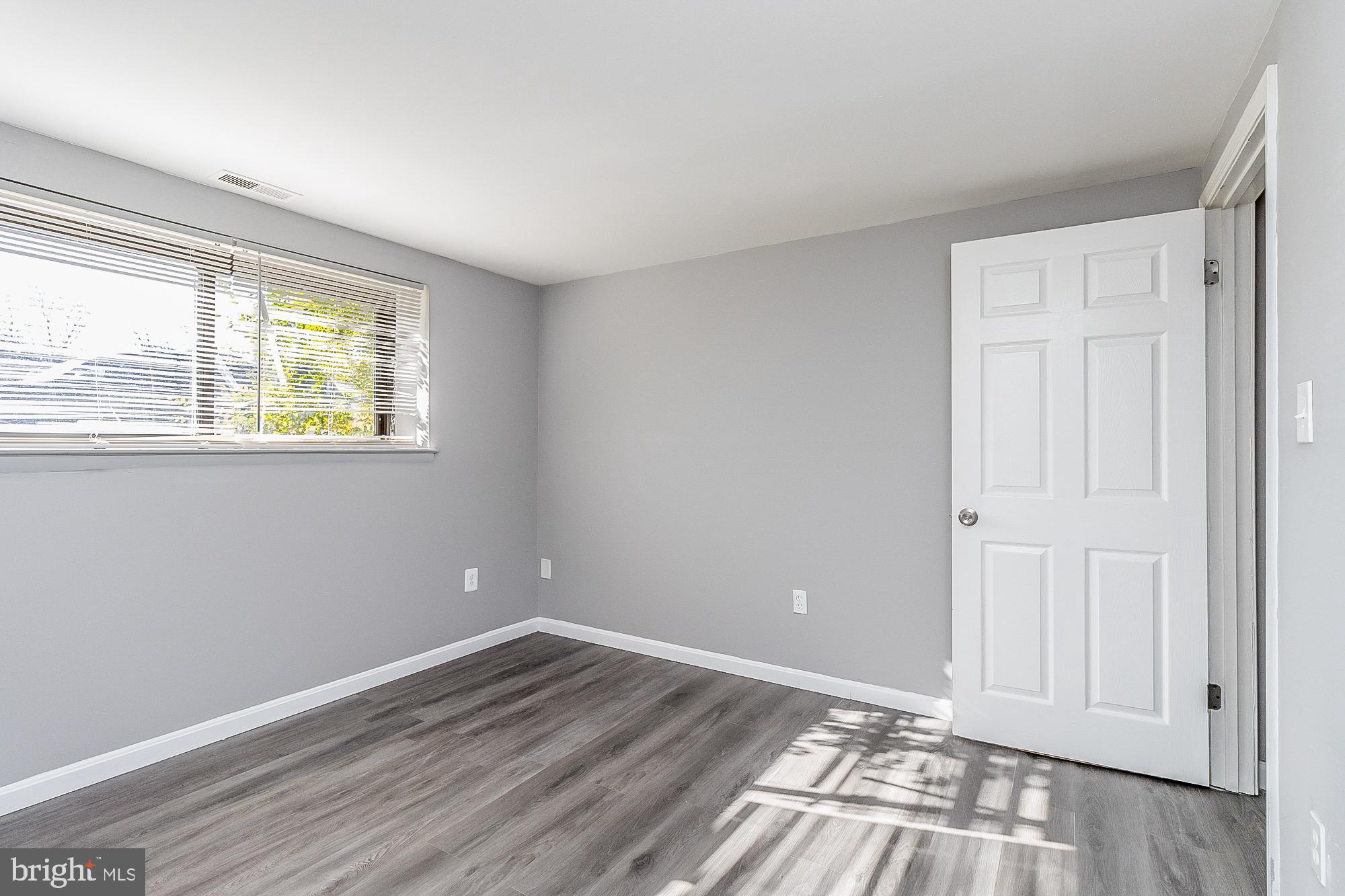 4006 Pinewood Avenue, Unit 1 Baltimore, MD 21206 - Photo 15 of 25 a view of empty room with wooden floor and fan