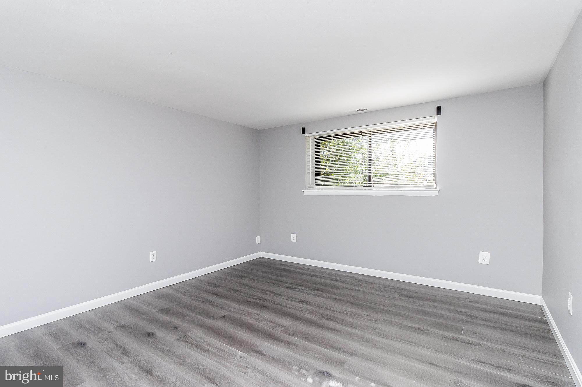 4006 Pinewood Avenue, Unit 1 Baltimore, MD 21206 - Photo 18 of 25 a view of room with wooden floor and windows in a room