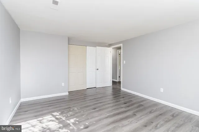 a view of an empty room and wooden floor