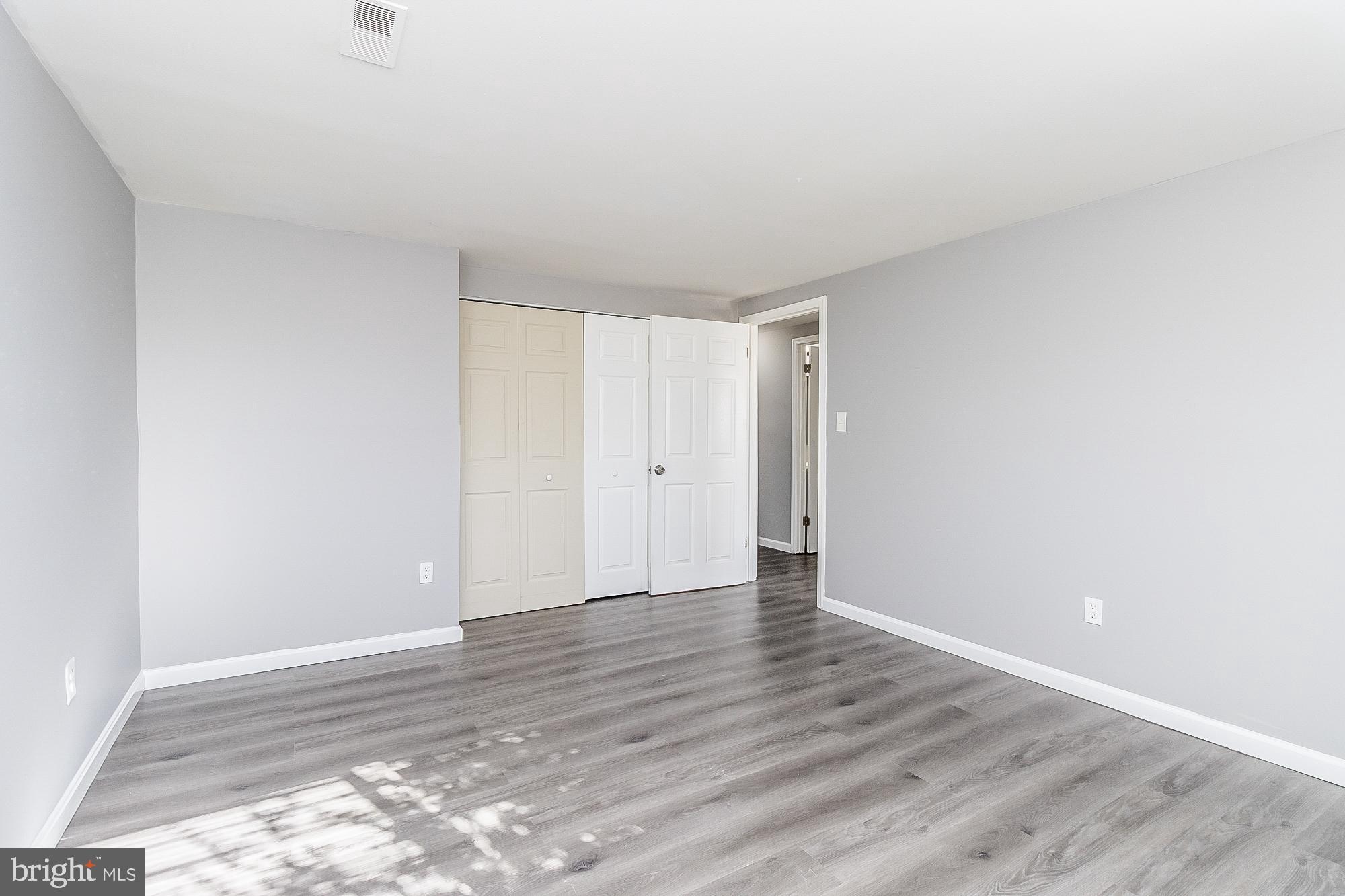 4006 Pinewood Avenue, Unit 1 Baltimore, MD 21206 - Photo 19 of 25 a view of an empty room and wooden floor