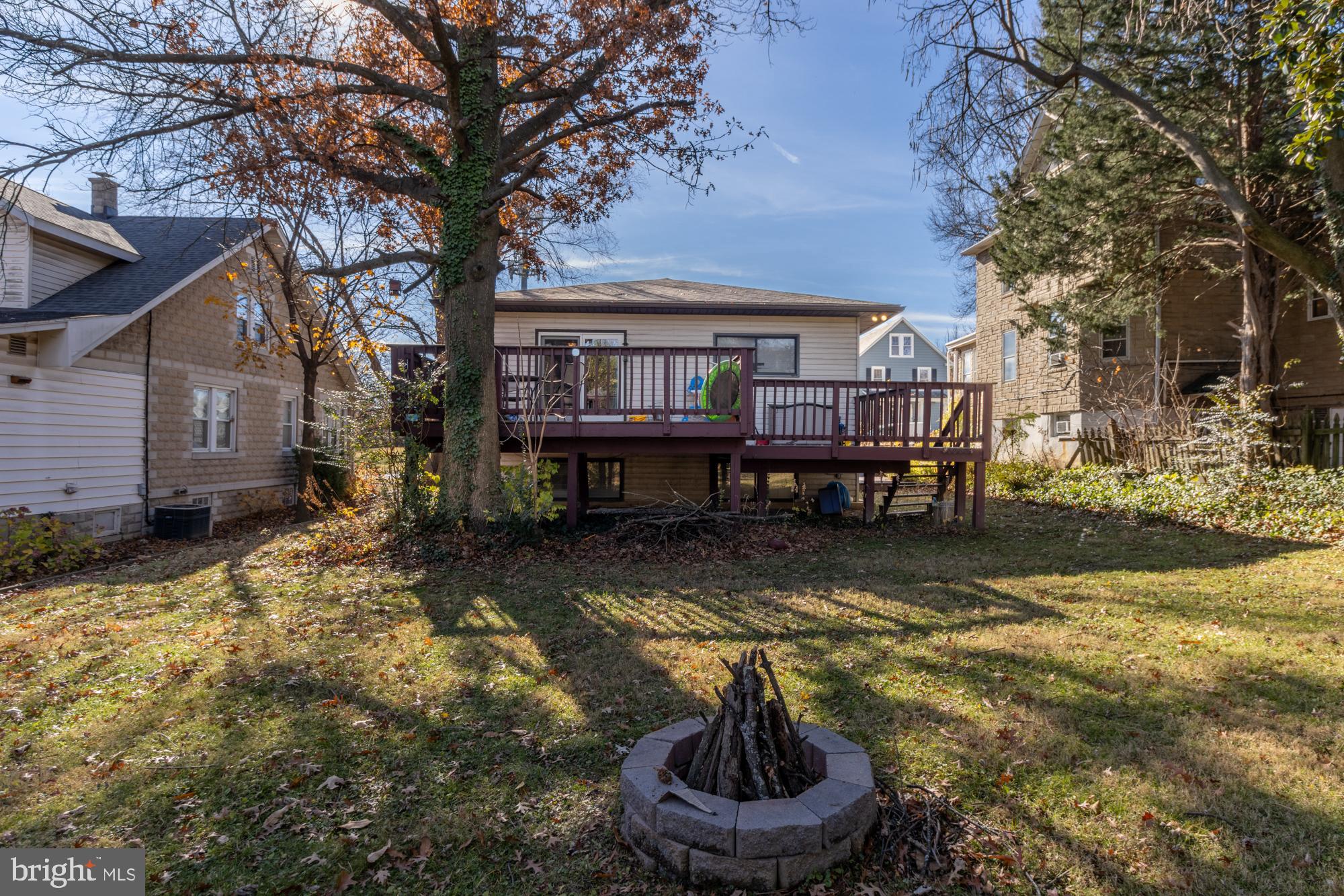 4006 Pinewood Avenue, Unit 1 Baltimore, MD 21206 - Photo 22 of 25 a front view of a house with a yard fire pit and outdoor seating