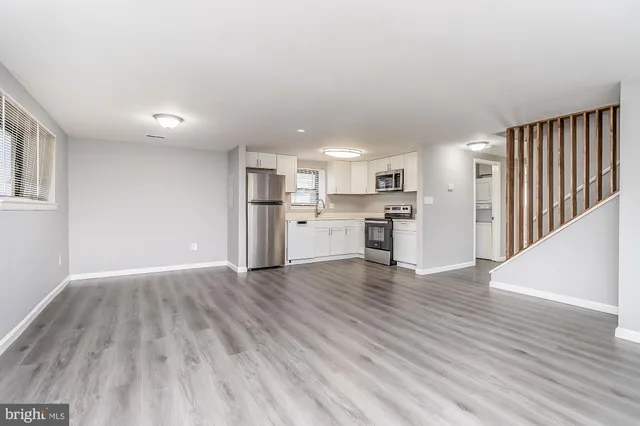 a view of kitchen with wooden floor and electronic appliances