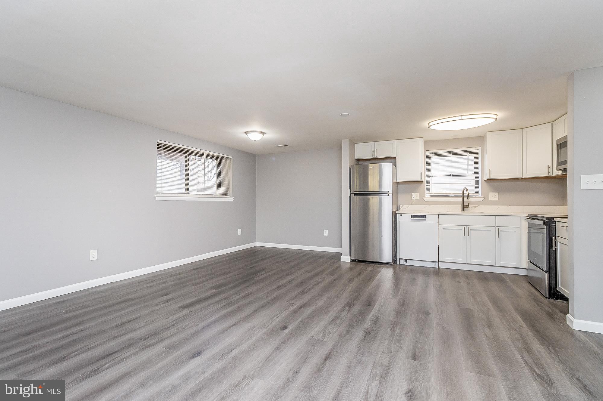 4006 Pinewood Avenue, Unit 1 Baltimore, MD 21206 - Photo 10 of 25 a view of a kitchen with wooden floor and electronic appliances