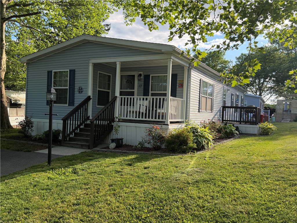 12 Springridge Road Bath, PA 18014 - Photo 42 of 61 A well-maintained facade with a welcoming porch and vibrant landscaping.