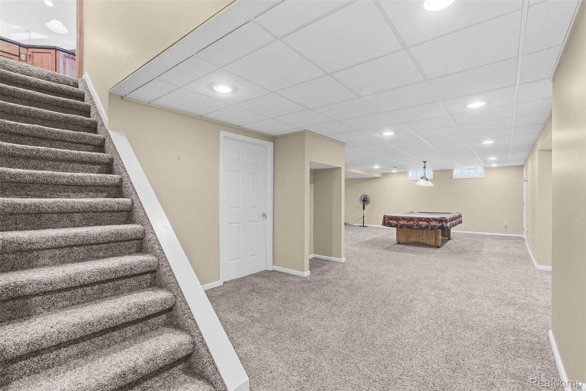8135 Ranch Estates Road Clarkston, MI 48348 - Photo 37 of 53 Carpeted staircase descending into a spacious lower level featuring recessed lighting and a drop ceiling