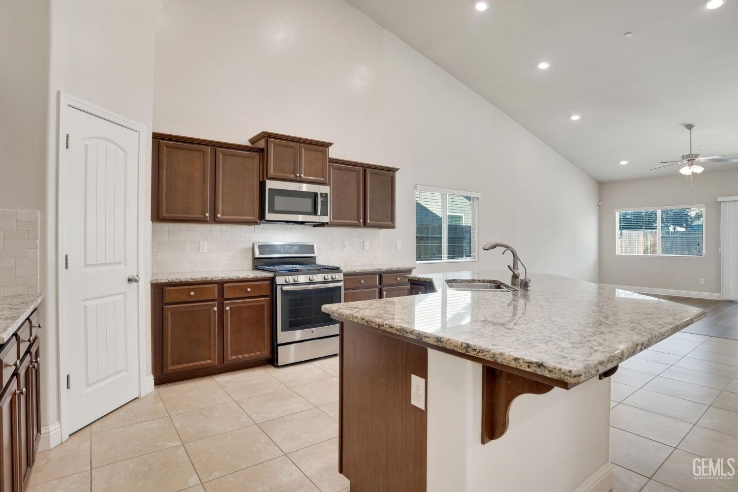 Undisclosed Address Bakersfield, CA 93311 - Photo 14 of 39 a kitchen with stainless steel appliances granite countertop a sink dishwasher stove and refrigerator