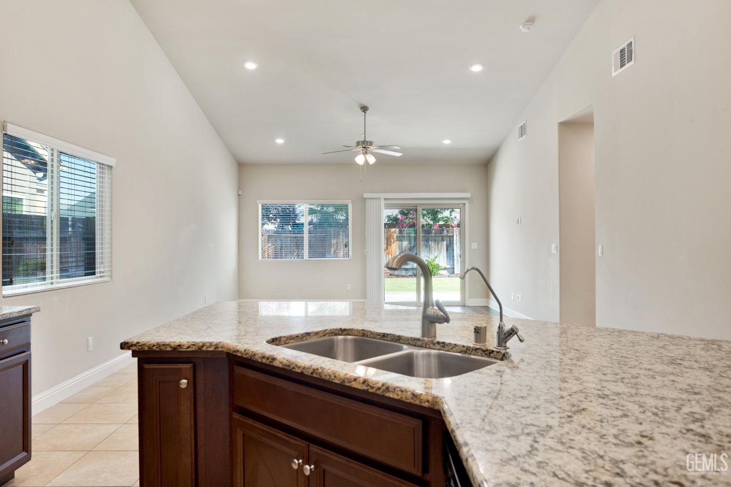 Undisclosed Address Bakersfield, CA 93311 - Photo 19 of 39 a kitchen with granite countertop a sink and a stove