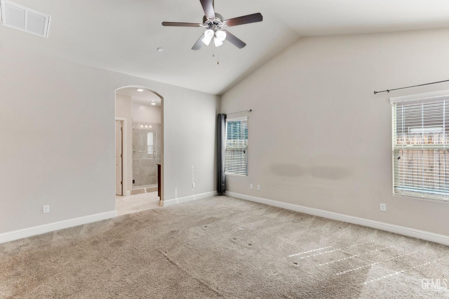 Undisclosed Address Bakersfield, CA 93311 - Photo 27 of 39 an empty room with chandelier fan and windows