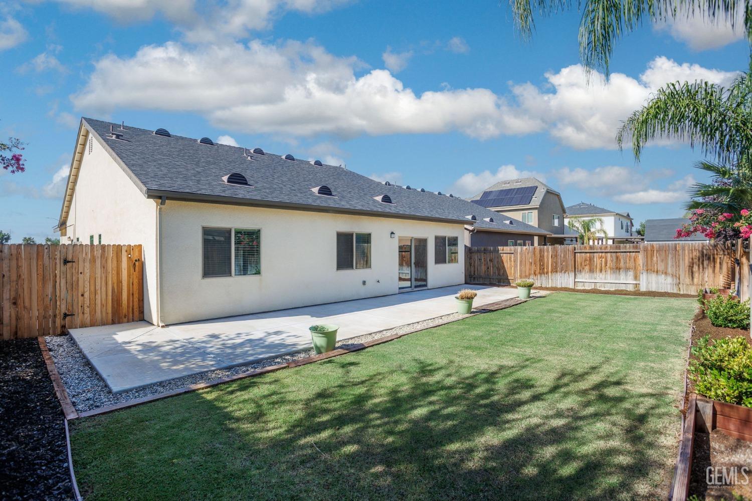 Undisclosed Address Bakersfield, CA 93311 - Photo 38 of 39 a backyard of a house with table and chairs