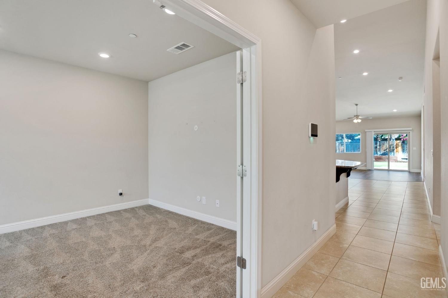 Undisclosed Address Bakersfield, CA 93311 - Photo 7 of 39 a view of a hallway with wooden floor