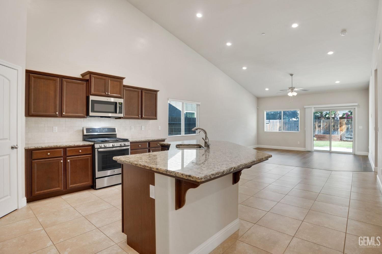 Undisclosed Address Bakersfield, CA 93311 - Photo 10 of 39 a kitchen with stainless steel appliances granite countertop a sink stove and cabinets