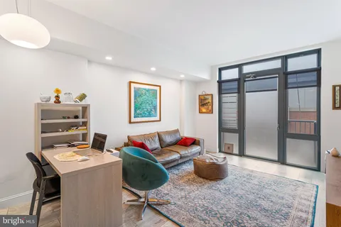 a living room with furniture and a rug