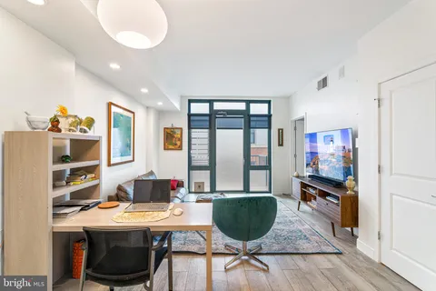 a workspace with furniture window and wooden floor