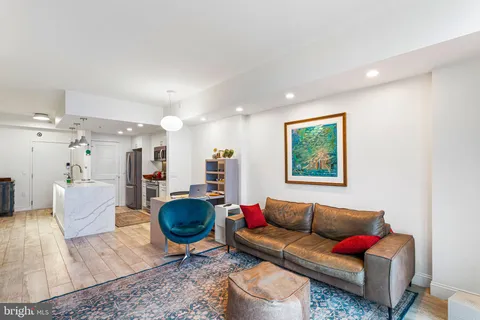 a living room with furniture a rug and a chandelier