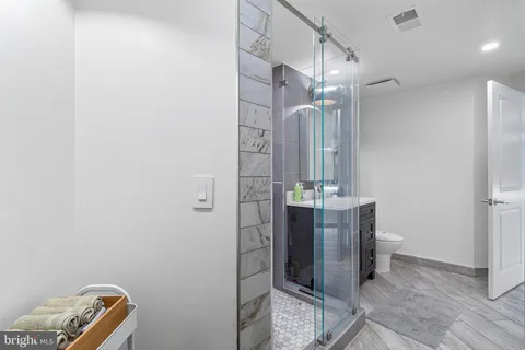 a bathroom with a mirror and a shower