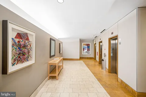 a hallway with wooden floor and furniture