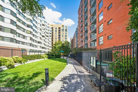 a view of a building with a yard and plants