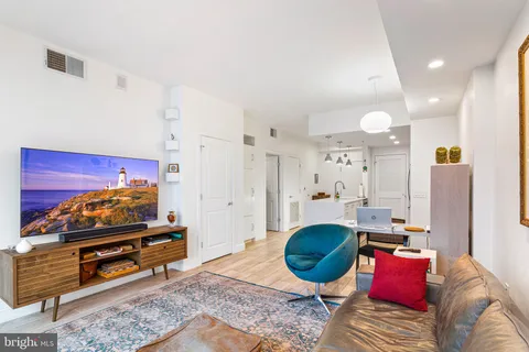 a living room with furniture gym equipment and a rug