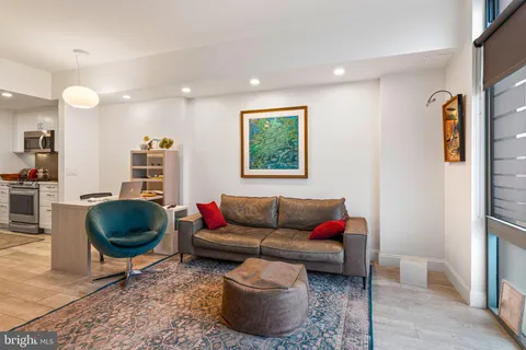 a living room with furniture and a rug