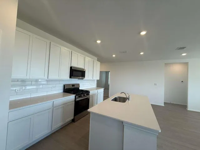 a kitchen with a sink a stove and refrigerator