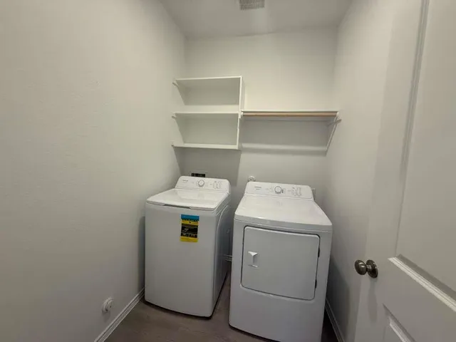 a view of a room with wooden floor