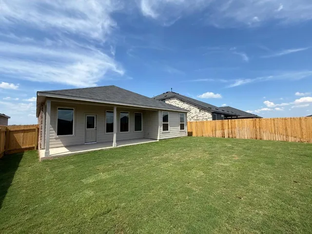 a view of a house with a backyard