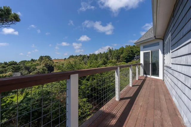 a view of a balcony with wooden floor