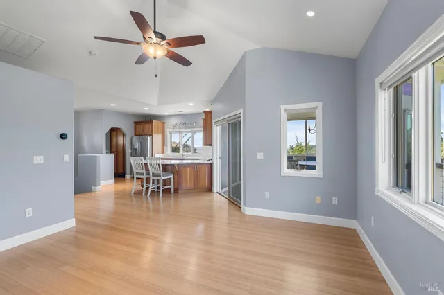 a view of a dining room with furniture and a window