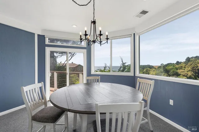a view of a dining room with furniture window and outside view