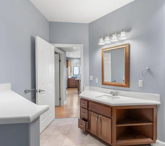 a bathroom with a sink a mirror and a shower