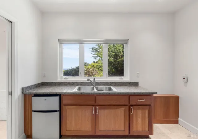 a kitchen with stainless steel appliances granite countertop a sink and a window
