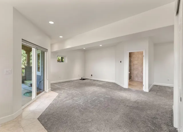 a view of an empty room with glass door