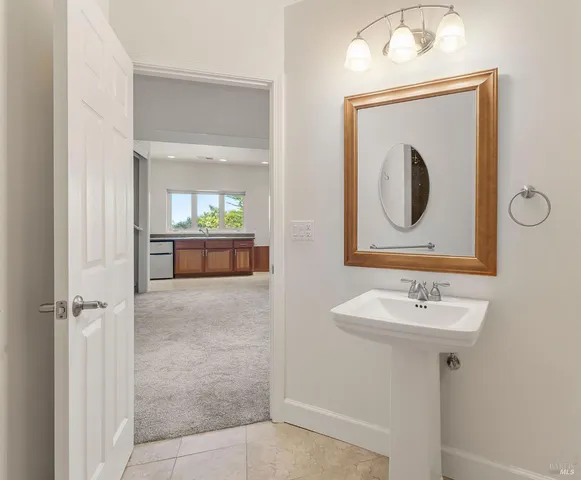 a bathroom with a sink a mirror and a toilet