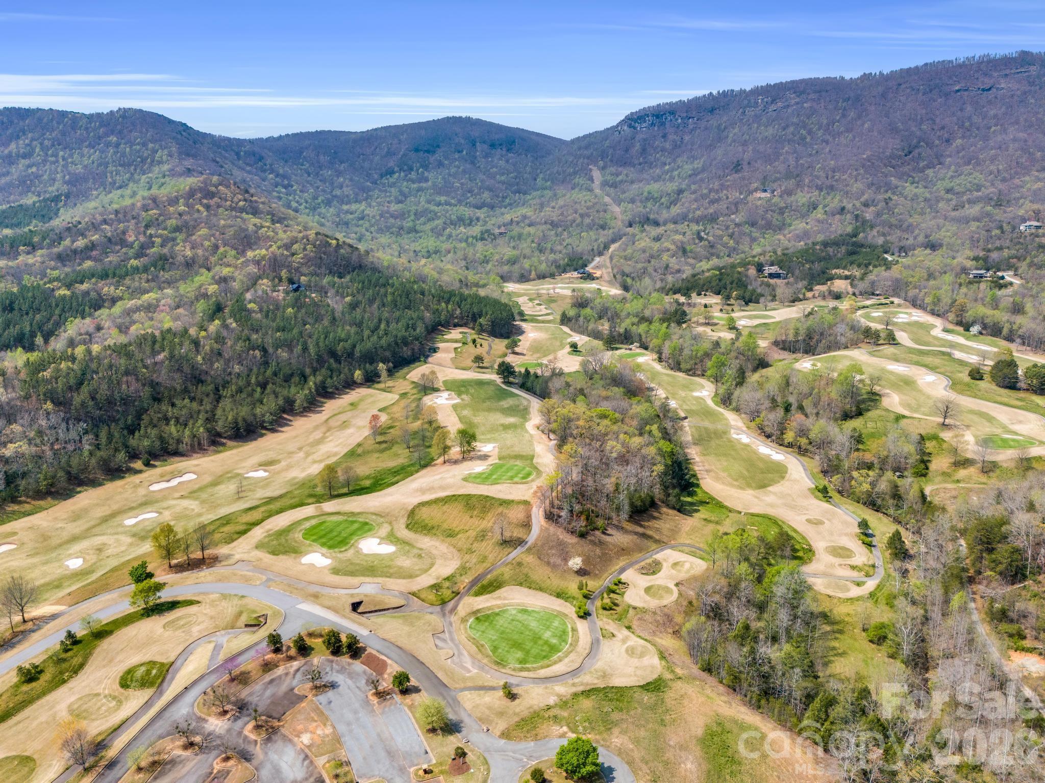 0 Deep Gap Farm Road East Mill Spring, NC 28756 - Photo 23 of 39 a view of a lush green hillside and a houses