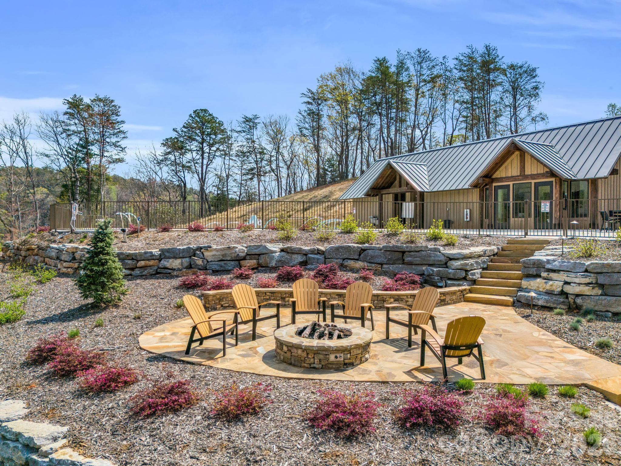 0 Deep Gap Farm Road East Mill Spring, NC 28756 - Photo 27 of 39 a view of a house with backyard water fountain and sitting area