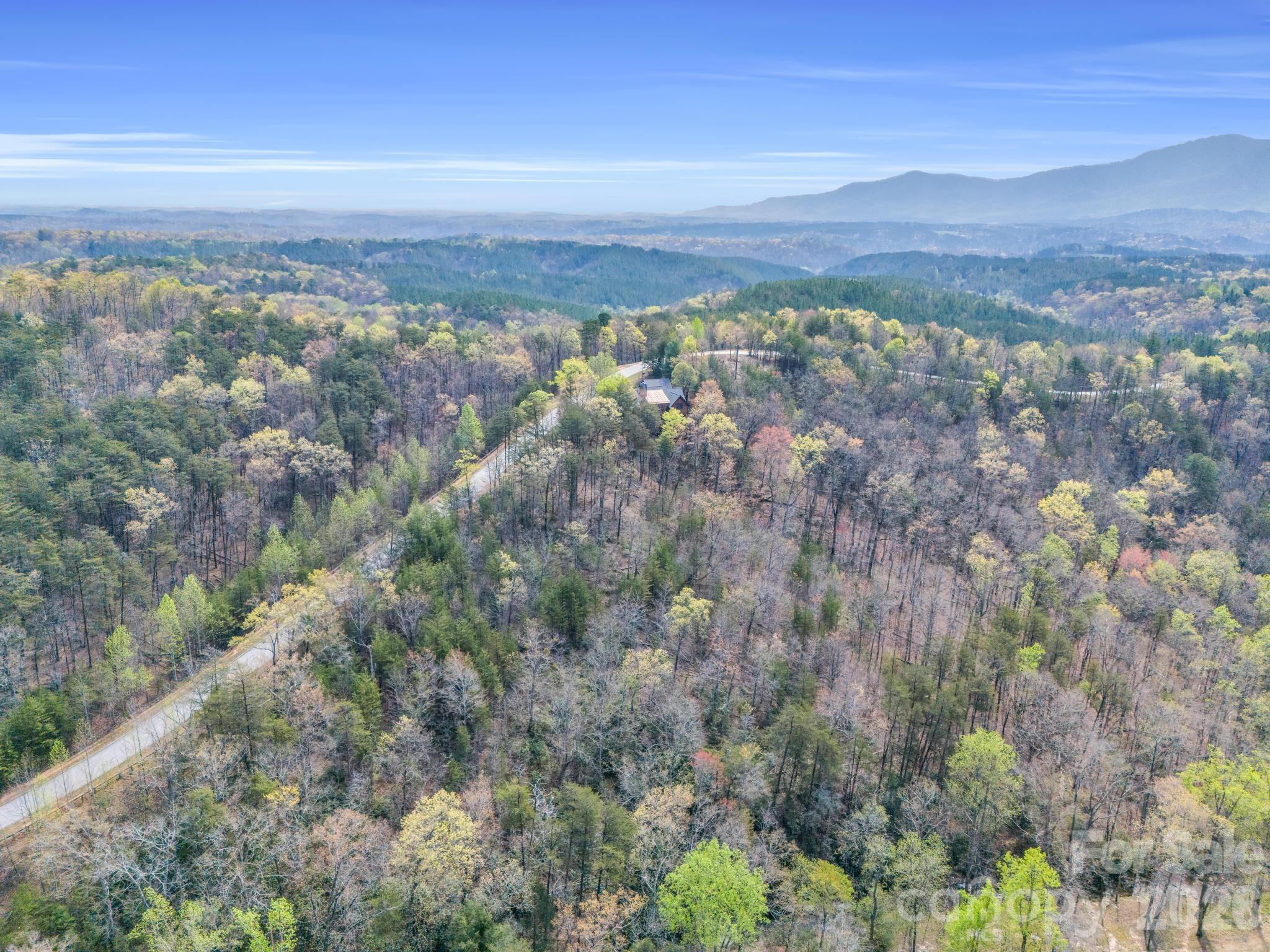 0 Deep Gap Farm Road East Mill Spring, NC 28756 - Photo 5 of 39 a view of a city with mountains in the background