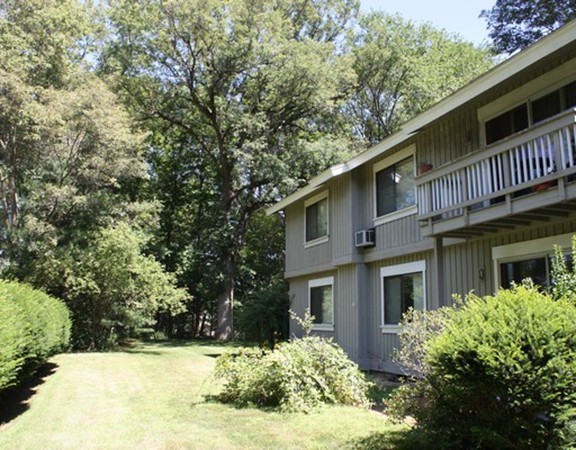 8 Ridge Road, Unit 1 Lincoln, MA 01773 - Photo 1 of 14 a front view of a house with a yard garage and outdoor seating