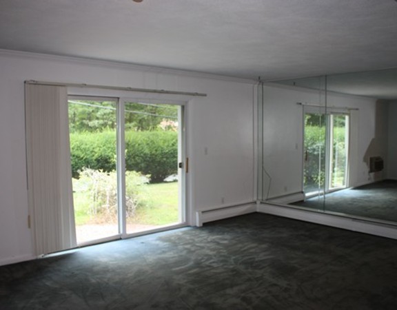 8 Ridge Road, Unit 1 Lincoln, MA 01773 - Photo 2 of 14 a view of livingroom with furniture and floor to ceiling window