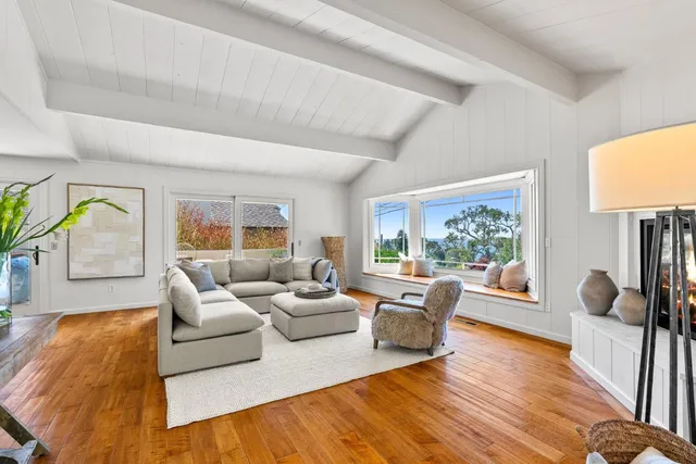 a living room with furniture and a flat screen tv with wooden floor