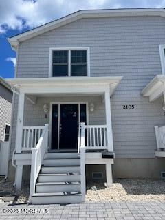2105 Grand Central Avenue, Unit 1 Lavallette, NJ 08735 - Photo 1 of 33 a front view of a house with stairs