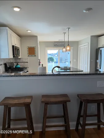 a kitchen with a table chairs and microwave