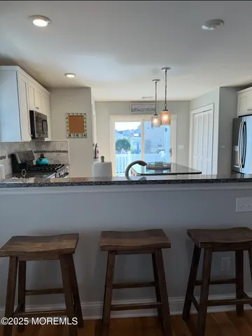 a kitchen with a table chairs and microwave