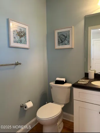 a bathroom with a toilet a sink and a mirror