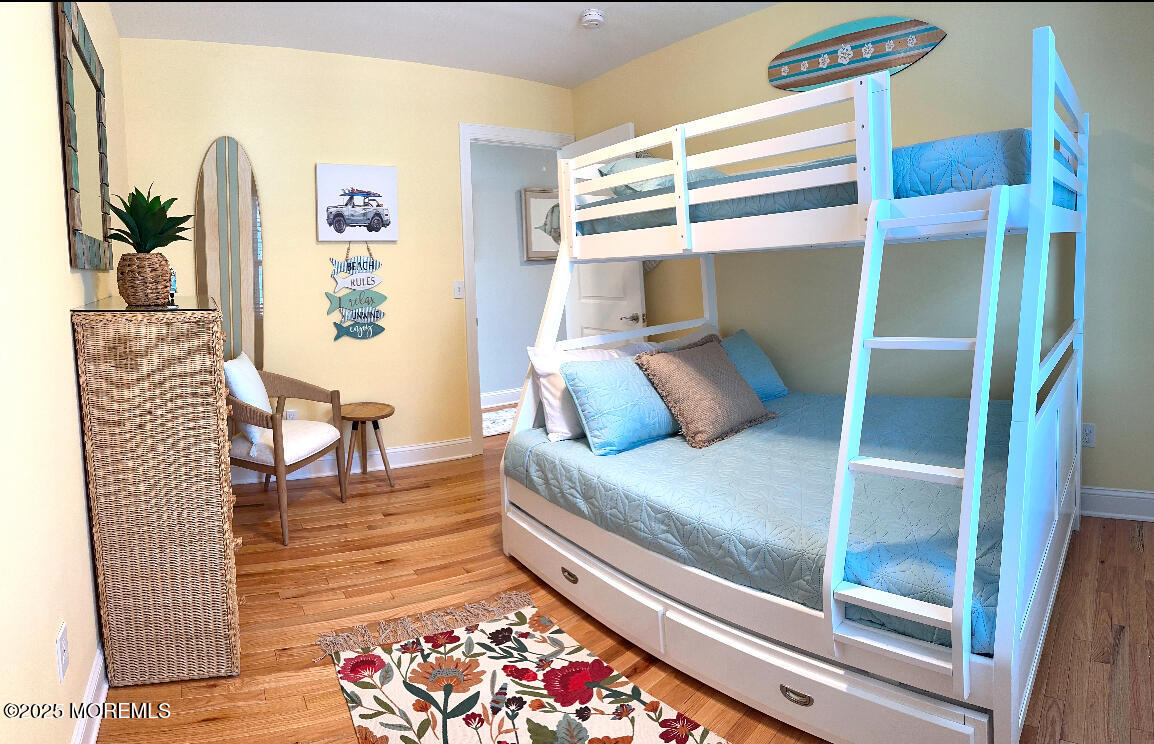 2105 Grand Central Avenue, Unit 1 Lavallette, NJ 08735 - Photo 20 of 33 a bedroom with a bed and a table in it