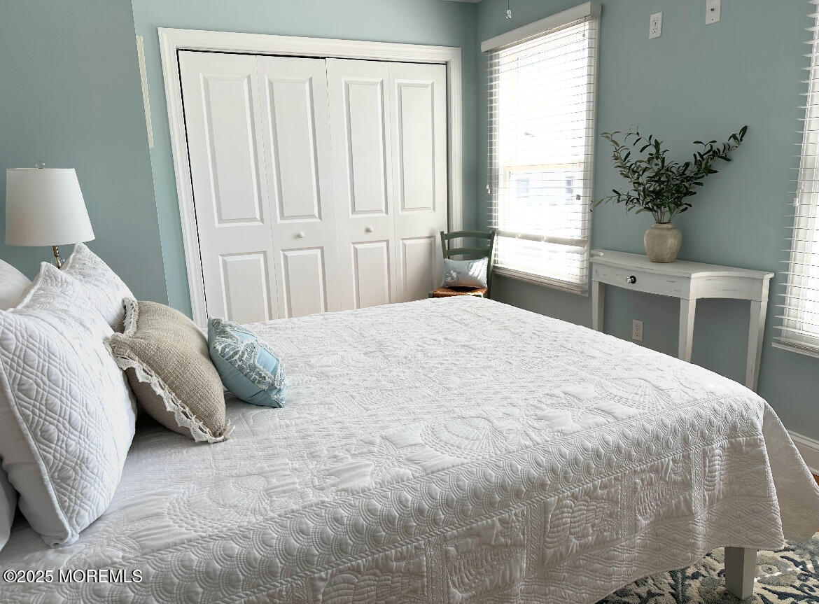 2105 Grand Central Avenue, Unit 1 Lavallette, NJ 08735 - Photo 24 of 33 a bedroom with a bed and a potted plant